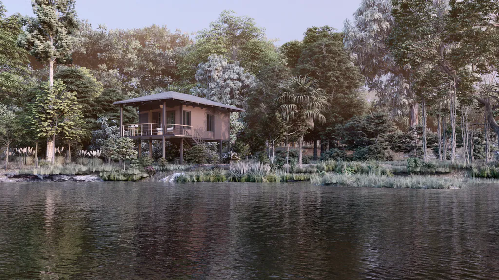A Darwin prebuilt cabin on stilts at the edge of a lake, among tall trees