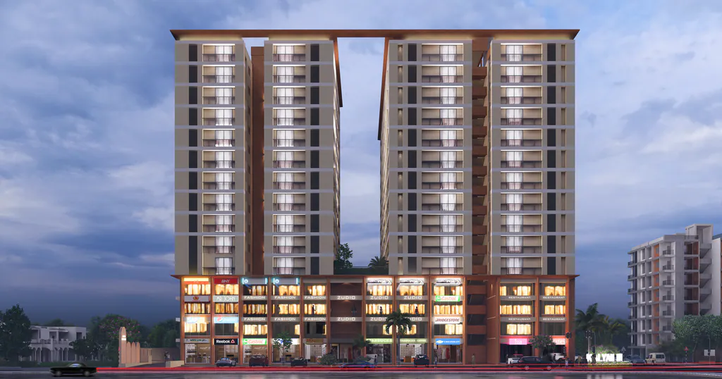 Kalyan Heritage at dusk: twin high-rise towers on a lit commercial podium