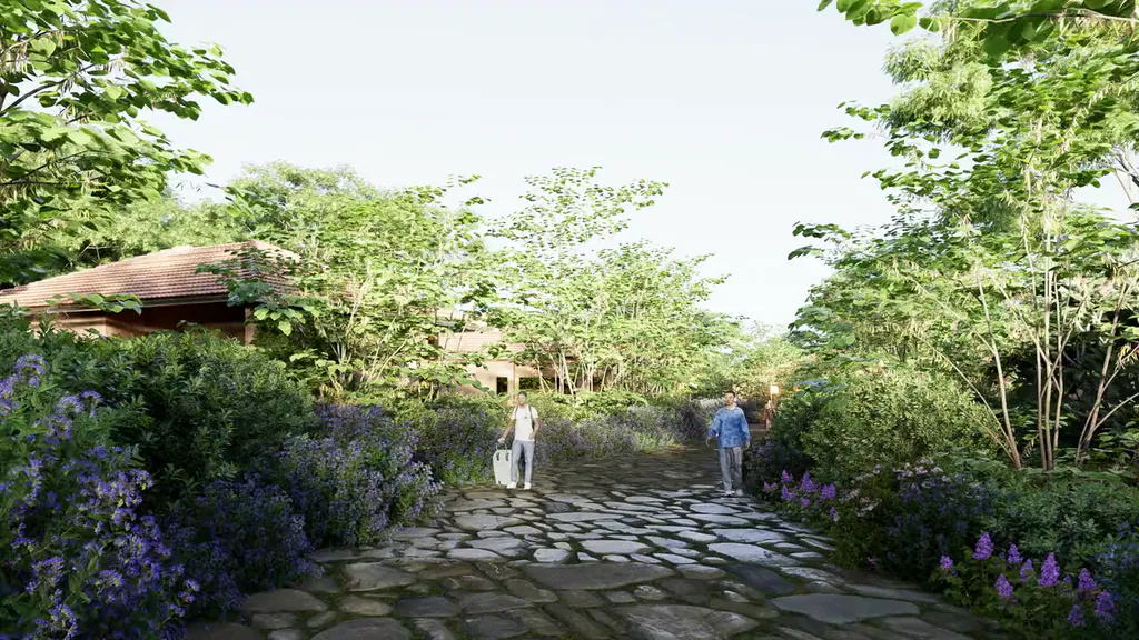 Morning on a stone path between brick cottages, people walking towards the camera