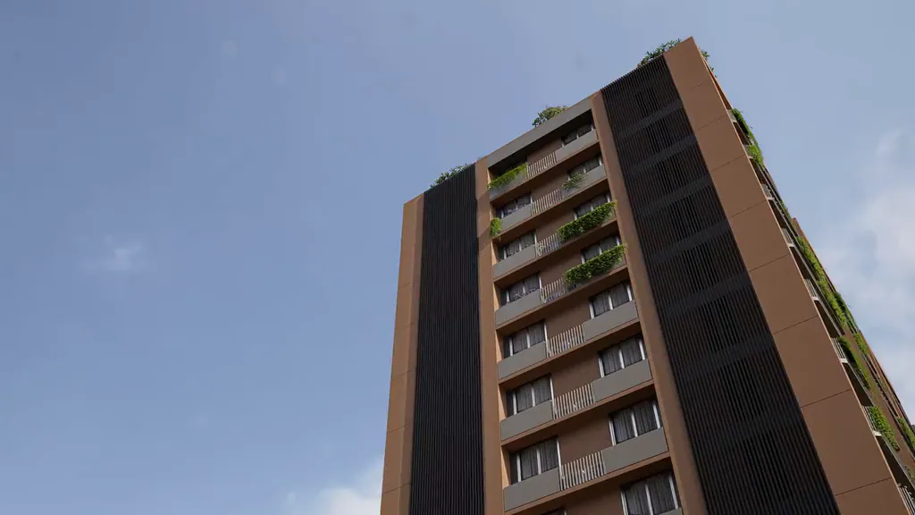 The camera rises along the Shreyas Arise tower against the sky