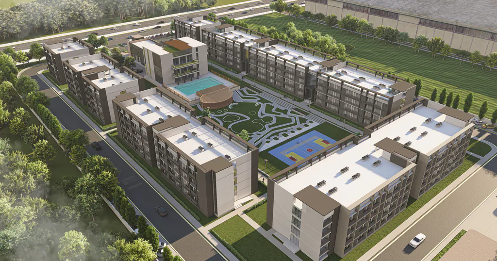 Aerial of Proton Township: four-storey blocks around landscaped courts, a pool and sports courts
