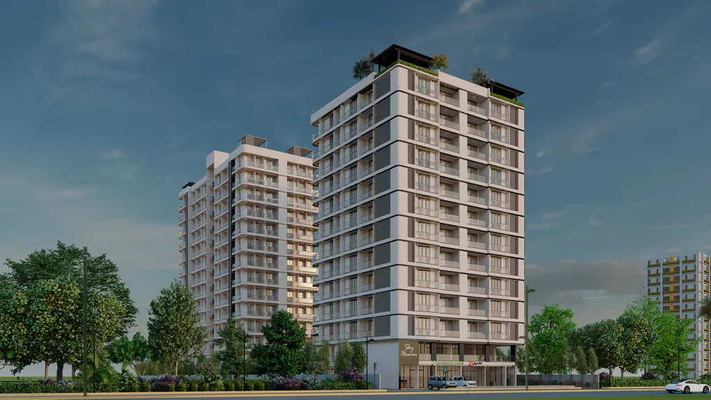 Sky Heaven in Vapi: two residential towers above trees under a blue evening sky