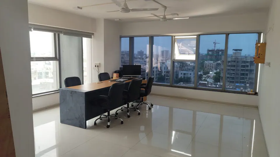 Another corner of the studio, with the city spread out below the window