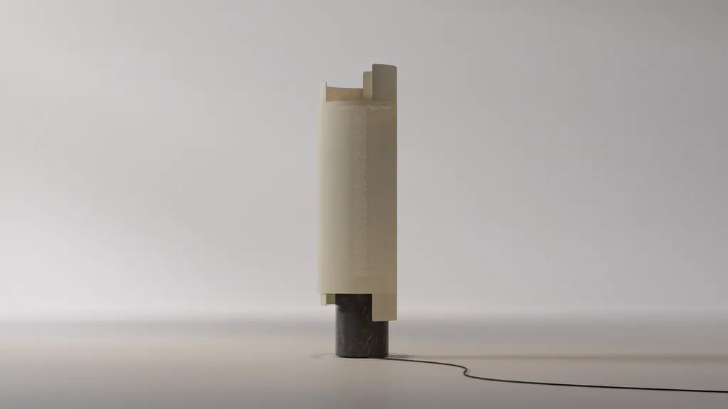 The Weave Stone lamp: a carved stone base with a jute-wrapped shade, standing in soft grey light